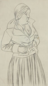 Stehende Frau, die Hände in den Jackentaschen.