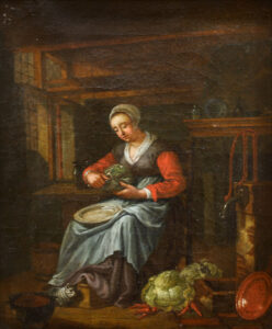 Kücheninterieur mit Dienstmagd beim Kohl schneiden.